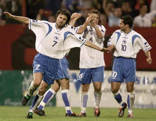 Bosnian players Hasan Salihamidzic (R), Zvjezdan Misimovic (2nd R) and Dusan Kerkez celebrate with teammate Elvir Bolic (L) after he scored a goal against Spain during their World Cup qualifier in Zenica, September 8, 2004. The match ended in a 1-1 draw. REUTERS/Damir Sagolj
